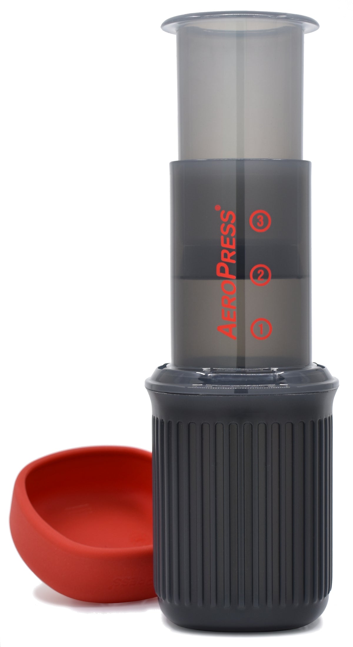 AeroPress Go seated on its mug beside the lid